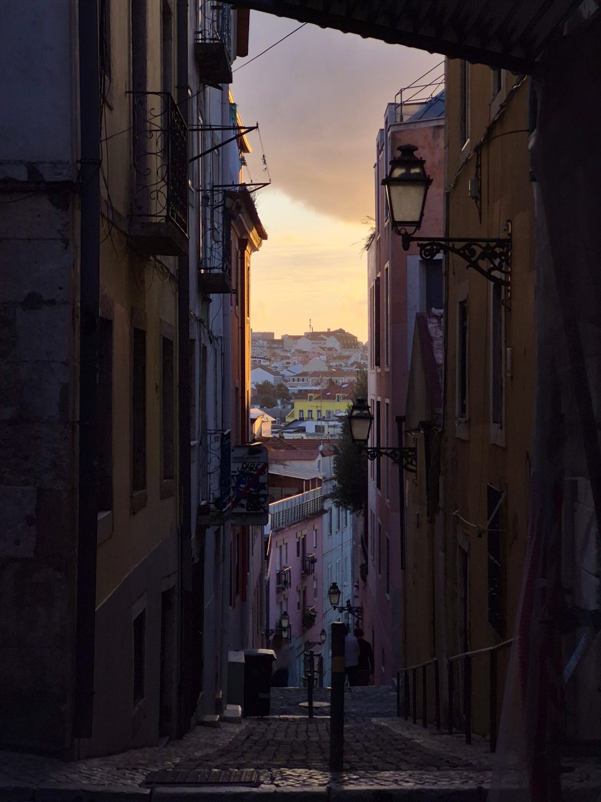 A cobblestone street in Lisbon at sunset